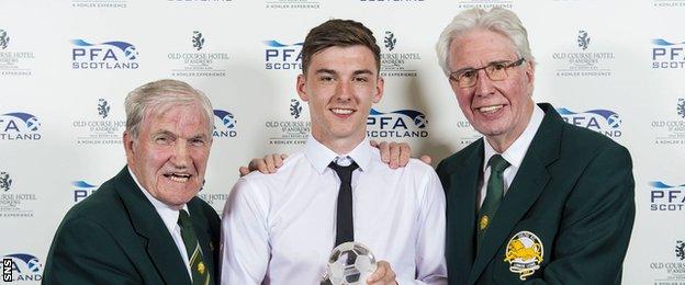 Kieran Tierney is presented with PFA Scotland's young player of the year award by Lisbon Lions Bertie Auld and Jim Craig