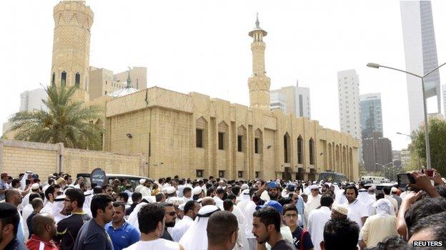 Crowds surround the Imam Sadiq Mosque after a bomb explosion