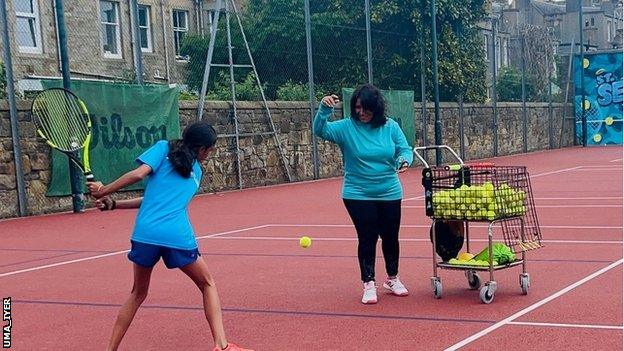 Uma Iyer coaching a child in Edinburgh