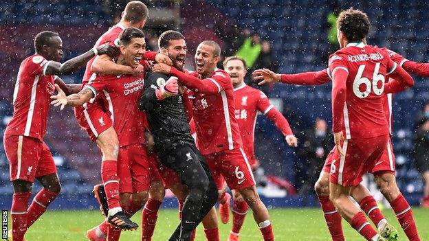 Liverpool celebrate after goalkeeper Alisson scores against West Brom