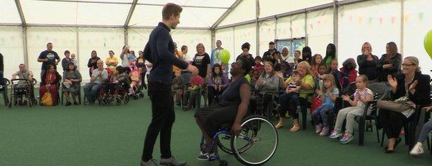 Goz and Ross performing in front of a crowd indoors