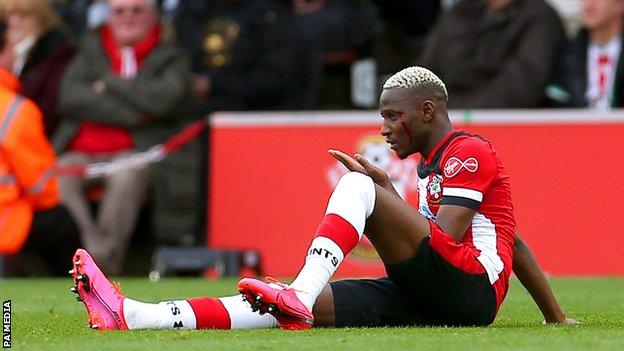 Moussa Djenepo sitting down after suffering a cut to his head