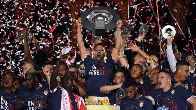 Radamel Falcao celebrates with the trophy and team mates after winning Ligue 1