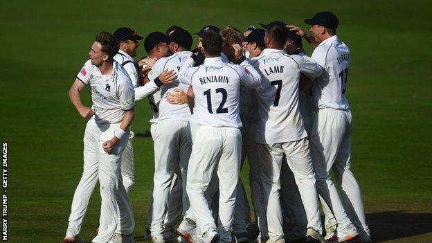 Warwickshire celebrate a wicket on their way to the Championship title last season