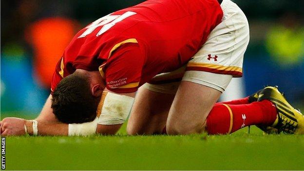 Alex Cuthbert sinks to the ground after Wales' World Cup defeat by South Africa