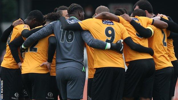 Maidstone United players huddle together