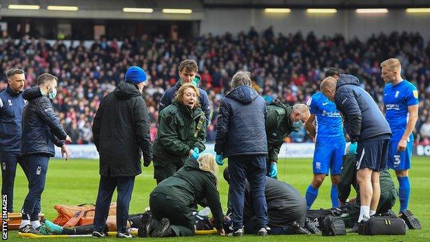 Neil Etheridge receives treatment at the City Ground