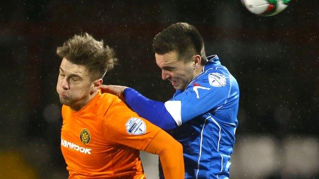 Carrick's Adam Salley fights out an aerial duel with Dungannon's Chris Hegarty at Seaview