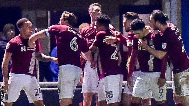 Northampton players celebrate Shay Facey's goal