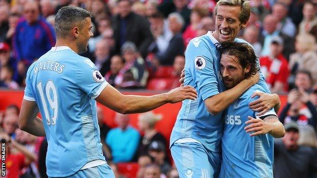 Stoke City players celebrate a goal against Manchester United