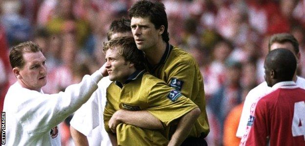 Sunderland striker Niall Quinn comforts Michael Gray after his penalty miss