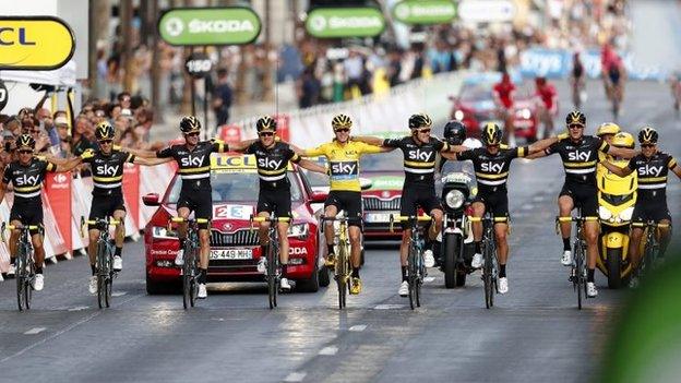 Chris Froome (in yellow) celebrates victory with Team Sky