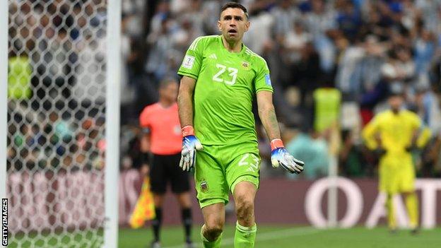 Emi Martinez does a dance of delight after France's Aurelien Tchouameni sens his penalty wide during the World Cup final shootout