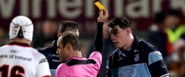 Referee Stuart Berry shows Cardiff Blues Seb Davies a yellow card