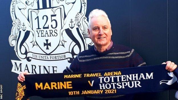 Marine chairman Paul Leary with a half and half scarf to commemorate Marine's FA Cup third round tie with Tottenham Hotspur