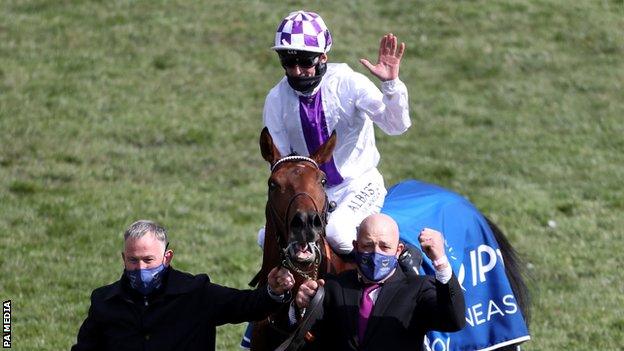 Poetic Flare, ridden by jockey Kevin Manning, (left) was a 16-1 winner