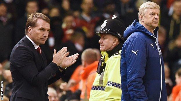 Brendan Rodgers applauds his Liverpool team as Arsene Wenger looks on