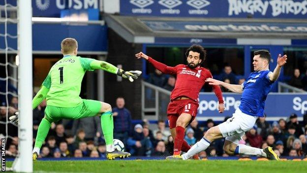 Michael Keane tackles Mohamed Salah