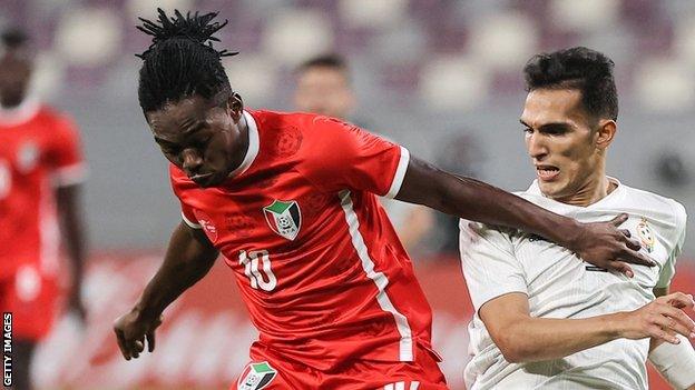 Mohamed Abdelrahman (left) in action for Sudan against Libya in a qualifier for the 2021 FIFA Arab Cup