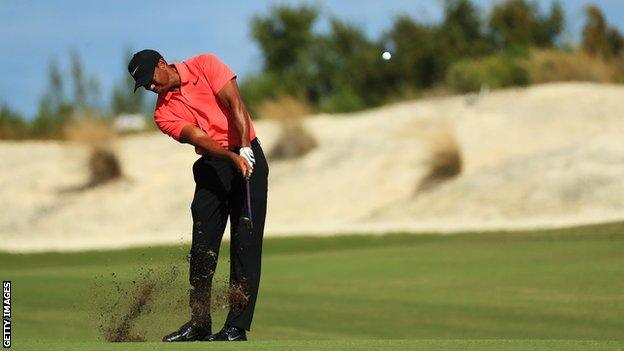 Tiger Woods plays an iron shot at the Hero World Challenge