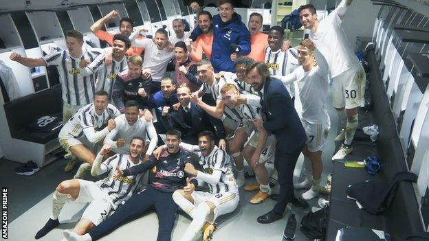 Juventus team celebrate in dressing room.