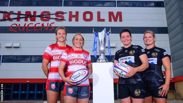 Gloucester and Exeter players pose with the Premier 15s trophy outside 'Queensholm' Stadium