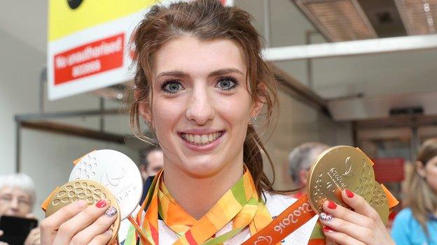 Bethany Firth returns to Northern Ireland with her three gold medals from the Rio Paralympics