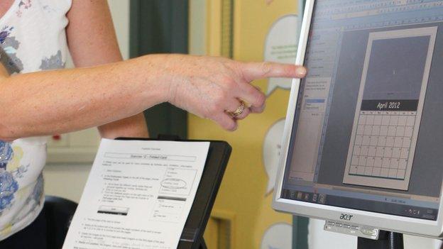 Woman pointing at computer screen