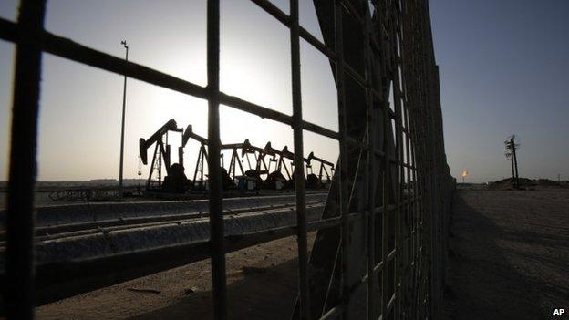 Oil pumps work in the desert oil fields of Sakhir, Bahrain