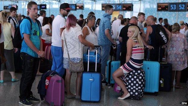 British tourists wait at the check-in as they leave Tunisia at the Enfidha International airport