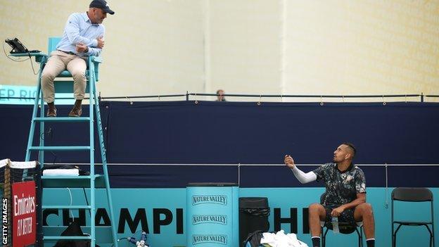 Kyrgios speaks with the umpire