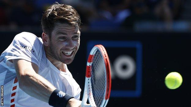 Cameron Norrie returns a ball against Sebastian Korda at the 2022 Australian Open