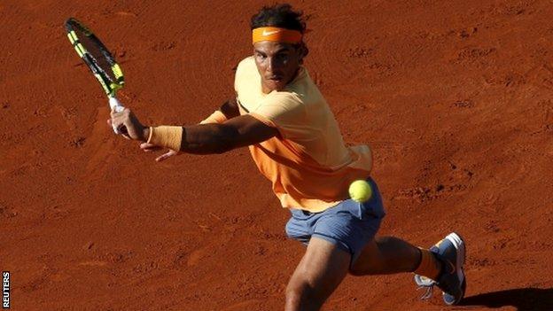 Rafael Nadal plays a backhand