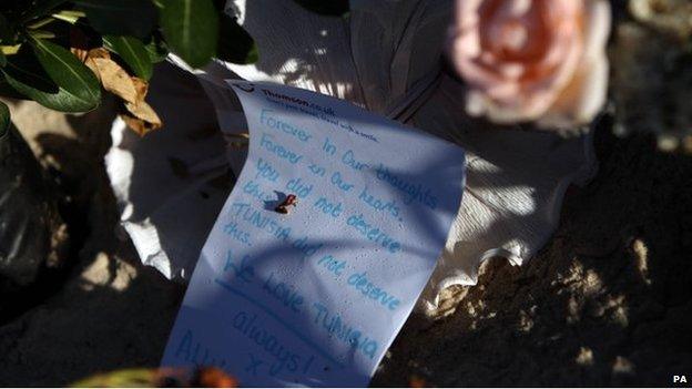 Flowers and letter in memory of victims on Sousse beach