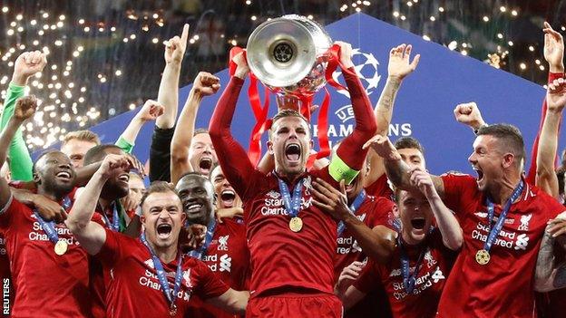 Liverpool captain Jordan Henderson lifts the Champions League trophy