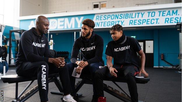 Jerry Rice speaking with students at the NFL Academy