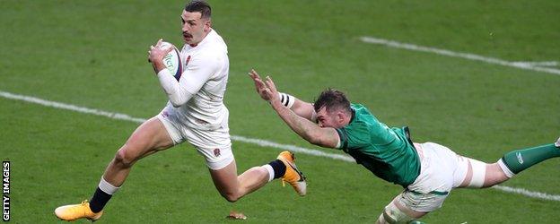 Jonny May runs away from an Irish tackle