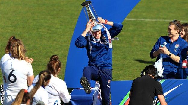 Simon Middleton dances with the Six Nations trophy on his head