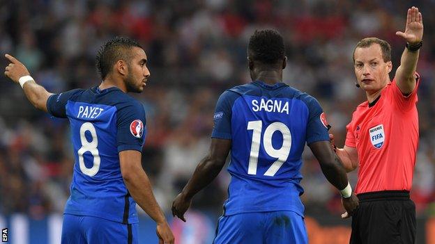 Dimitri Payet and Bacary Sagna of France with referee Willie Collum