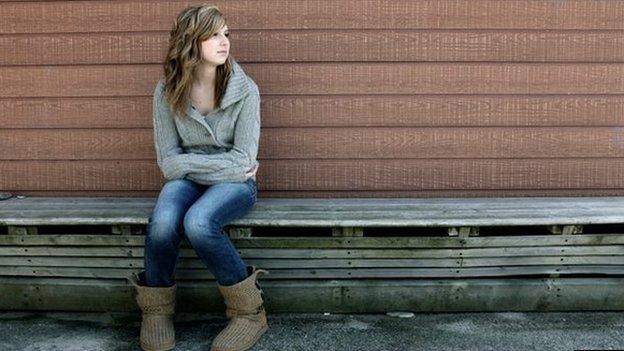 Lonely girl on bench