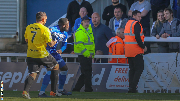 Jai Reason of Dover Athletic holds back Hartlepool United's Gus Mafuta following abuse from the crowd