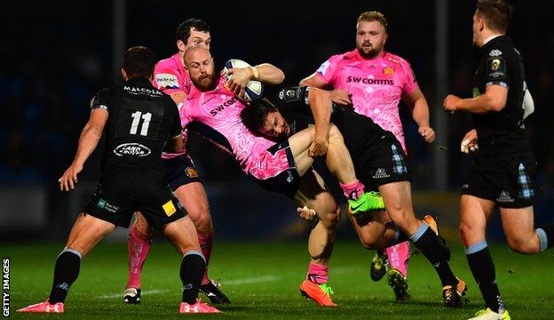 James Short of Exeter Chiefs is tackled by Glasgow's Sam Johnson