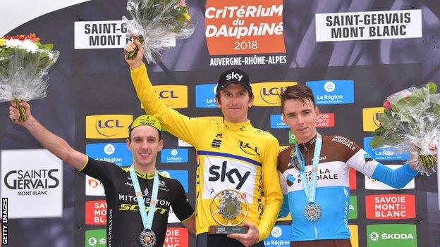 Geraint Thomas (c) celebrates victory over Adam Yates (R) & Romain Bardet (L)