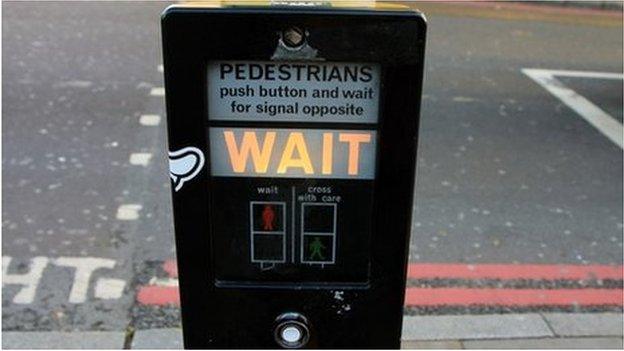 An illuminated wait signal at a pedestrian crossing