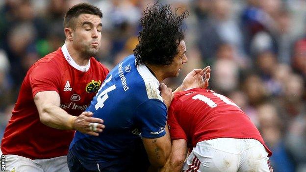 Munster's Ireland pair Conor Murray and Keith Earls tackle Leinster's Isa Nacewa