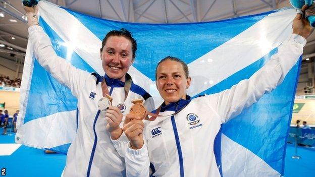 Katie Archibald and Neah Evans hold the Scotland flag aloft after winning silver and bronze medals in the women's points race