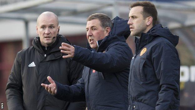 Mark McGhee flanked by a match official and James McFadden