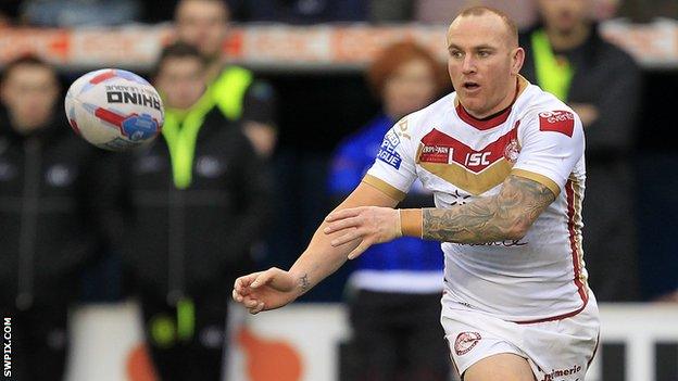 Luke Walsh passes the ball towards his right for Catalans Dragons against Widnes Vikings