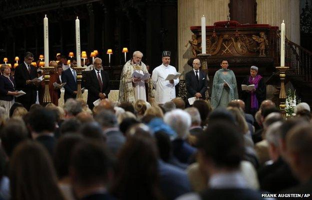 Members of various religious groups pray during a service in St Paul's Cathedral