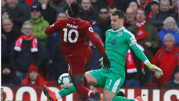 Sadio Mane goes round Tom Heaton before scoring Liverpool's fourth goal